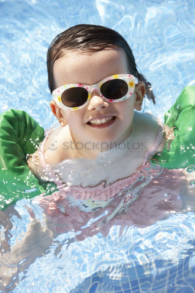 Similar – One little happy boy playing on the inflatable circle in swimming pool at the day time. Concept of friendly family.