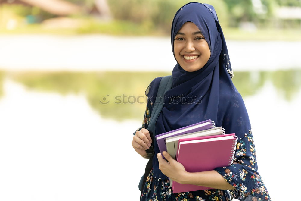 Similar – Smiling young woman wearing hijab outdoors