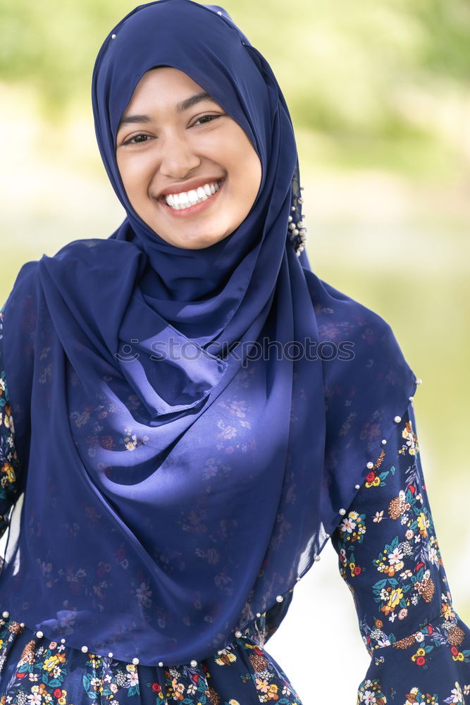 Similar – Smiling young woman wearing hijab outdoors