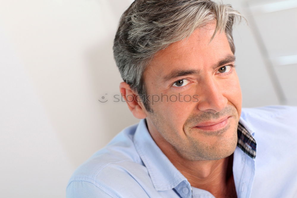 Similar – Portrait of a smiling senior with grey hair and grey beard in front of a grey sky