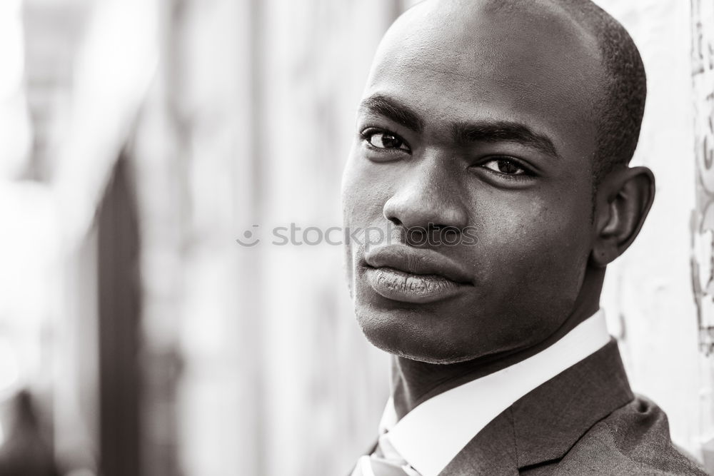 Similar – Handsome afro-american man biting his lip and looking aside in Gran via, Madrid.