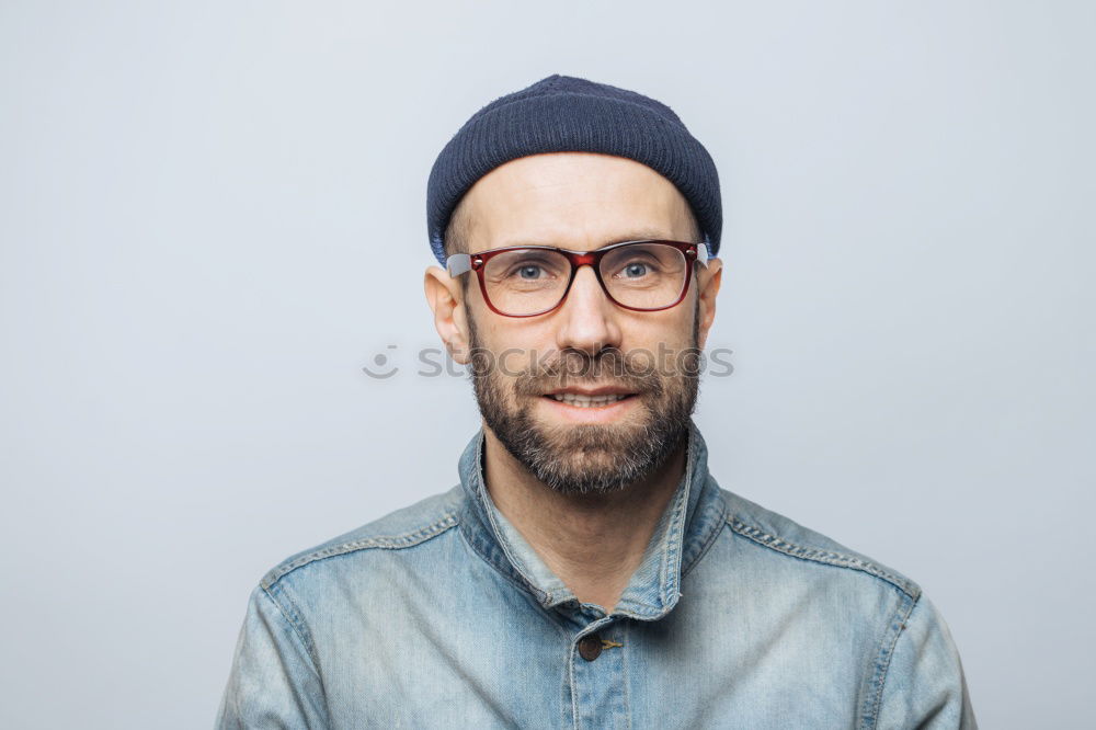 Similar – Man with mustache and glasses standing with crossed arms.