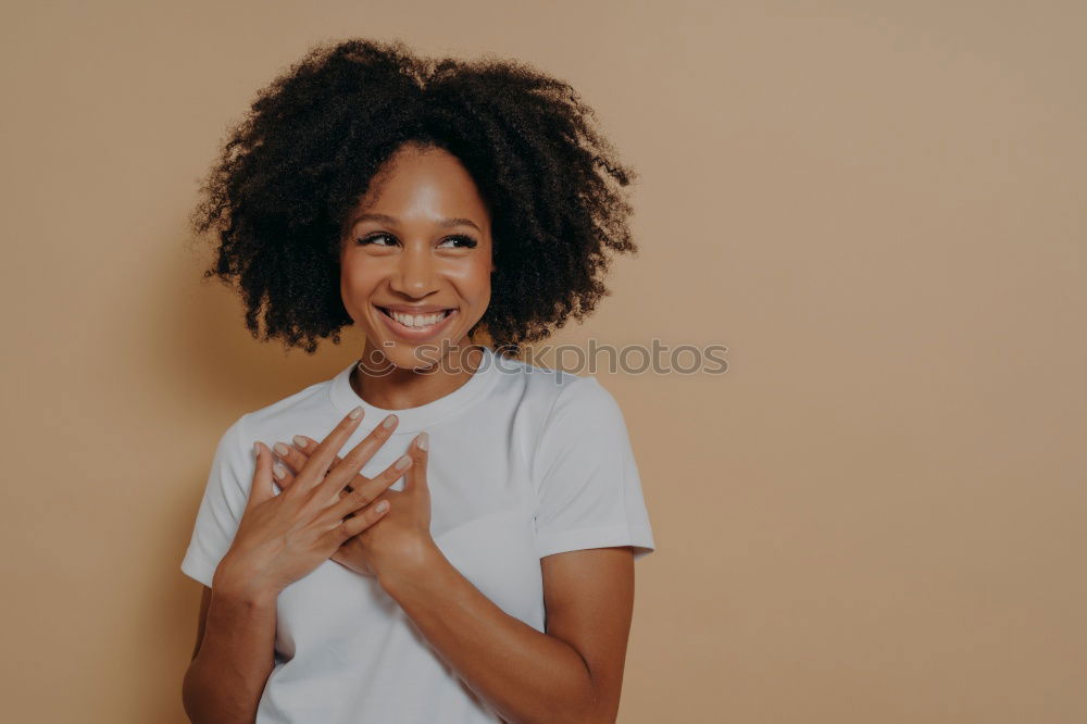 Similar – close up of a pretty black woman with curly hair smiling and lying on bed looking at the camera