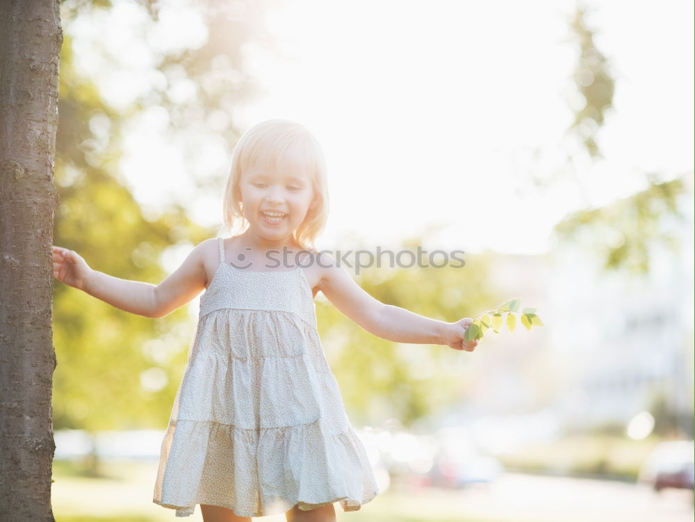 Similar – Cute black boy having fun on a swing in his parents garden