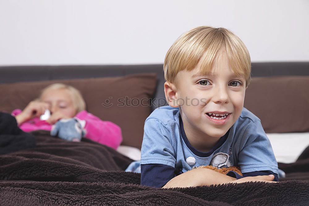 Similar – Image, Stock Photo Kids playing video game sitting on sofa at home