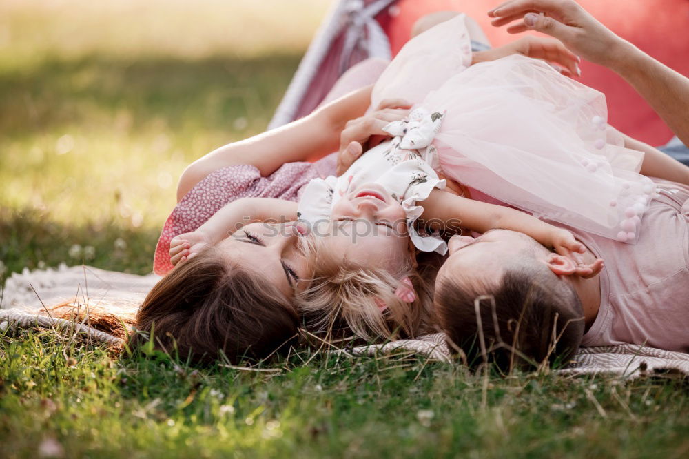 Similar – Young couple under blanket with hot drink kissing outdoors