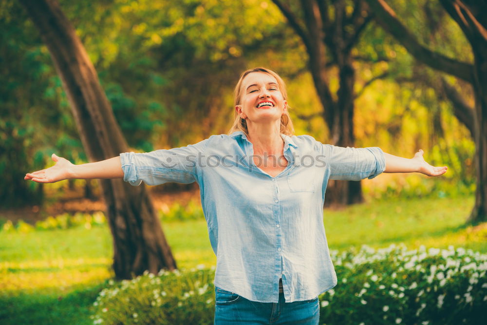 Similar – Happy senior woman sitting on the grass