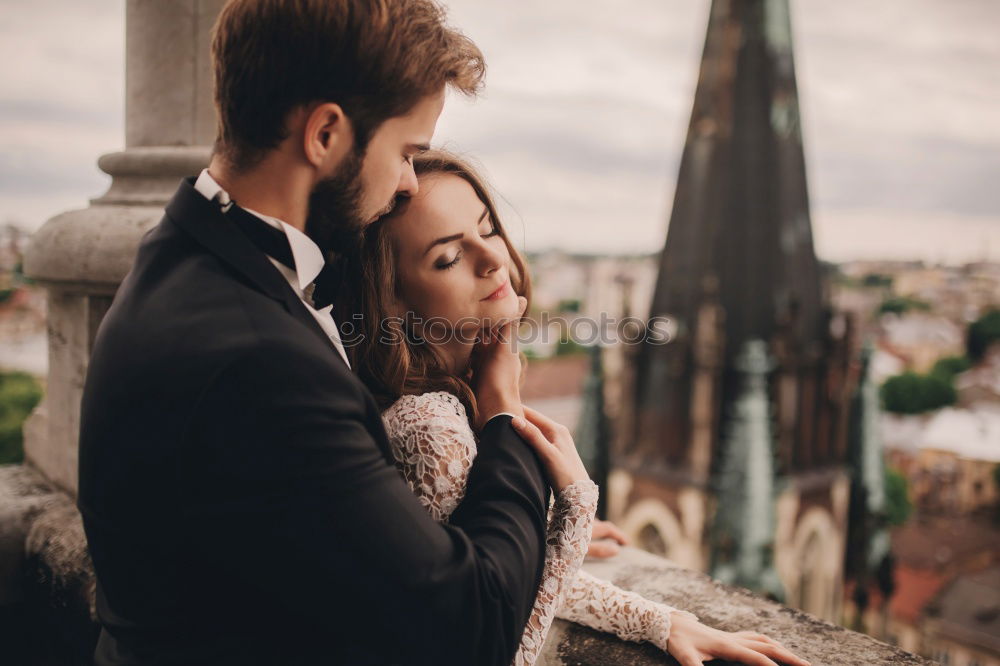 Similar – Image, Stock Photo Couple hugging each other on rooftop. Girl kissing guys forehead