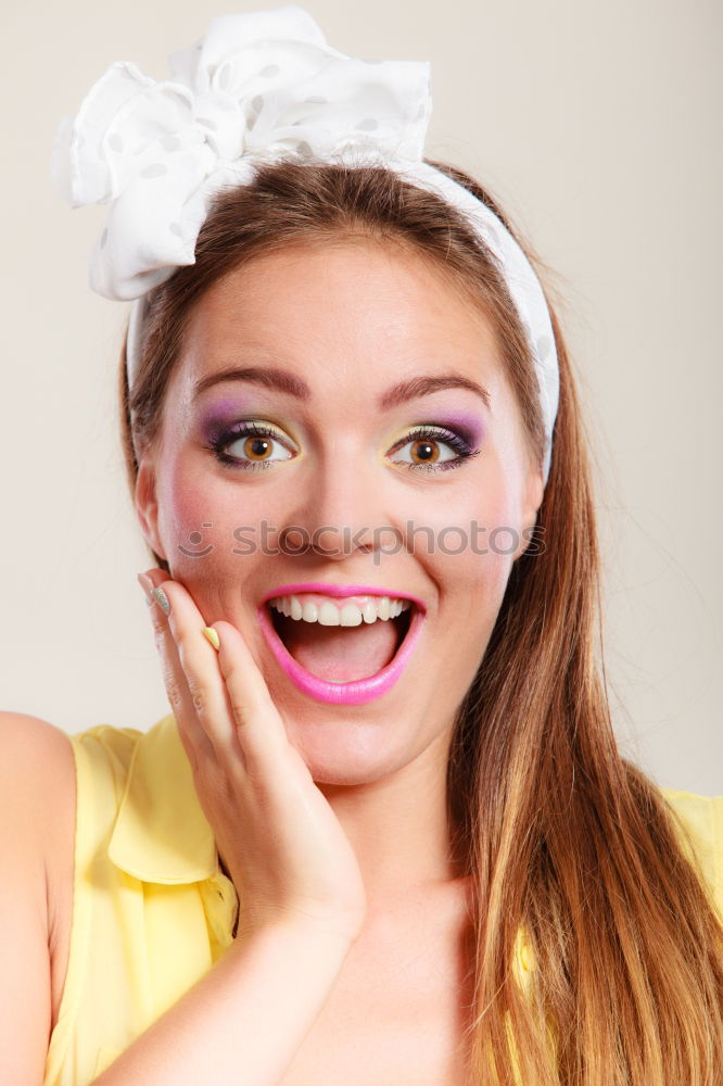 Similar – Young woman with pink hair is holding colorful lollipops