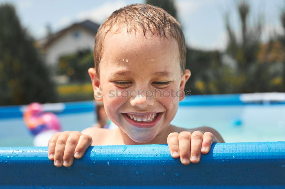 Similar – Image, Stock Photo Young boy in inflatable tube swimming with a big smile on his face