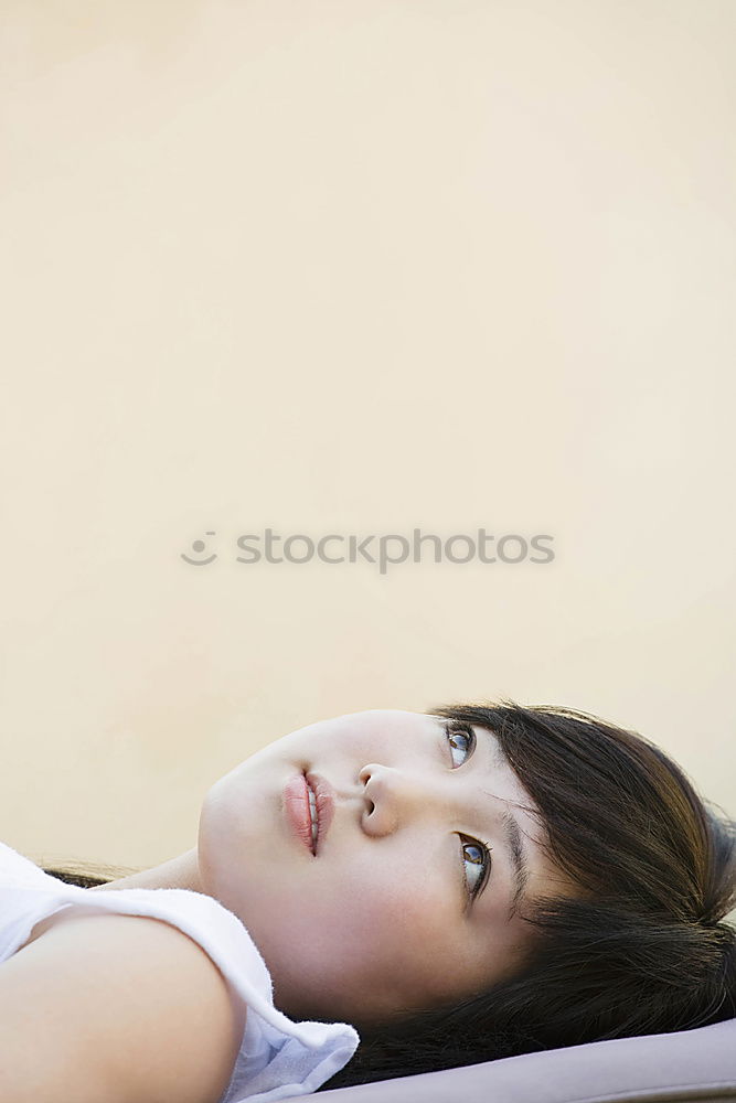 Similar – Portrait of a cute little girl with colored bracelets lying on her arm