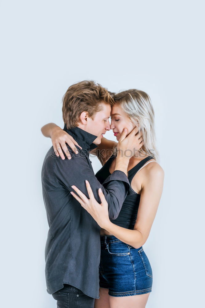 Similar – Image, Stock Photo Kissing couple at stone wall with metal decorated bars