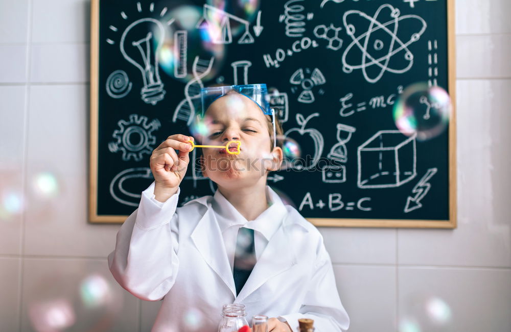 Similar – Image, Stock Photo Boy dressed as chemist with dirty face after doing an experiment