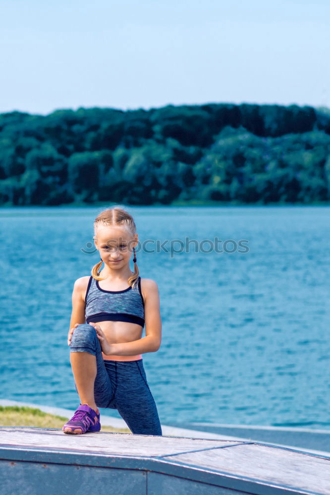 Similar – Playful girl standing in pier near lake