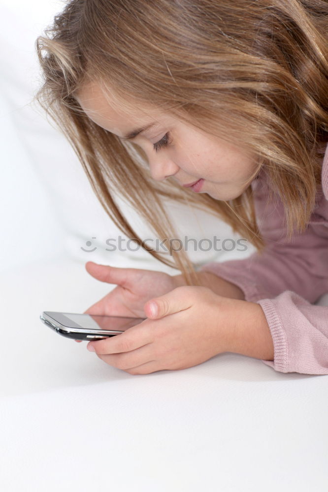 Similar – portrait of a beautiful kid using mobile phone