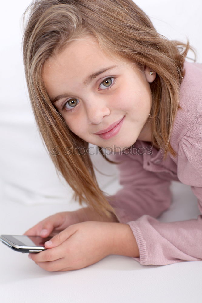 Similar – portrait of a beautiful kid using mobile phone