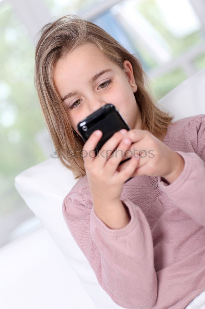 Similar – Image, Stock Photo Teenage girl listening to music and chatting with friends on smartphone sitting in hammock at home