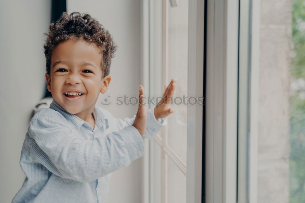 Similar – Cute male toddler laying on bed looking at camera