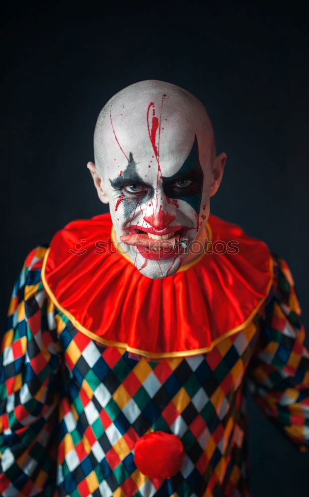 Similar – boy dressed as a clown on black background