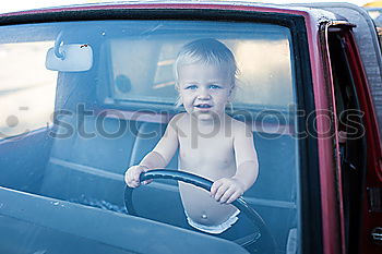 Image, Stock Photo One little boy sitting in the car and look out from the car window at the day time. Concept of happy trip.