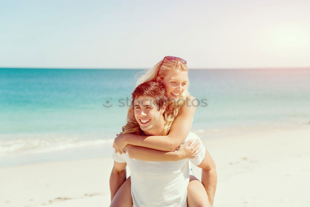 Father and daughter with balloons playing on the beach