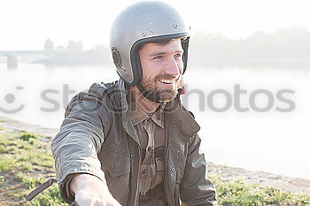 Similar – Man on bike at garage