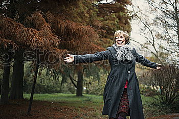 Similar – Happy senior woman sitting on the grass