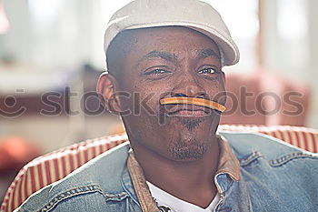 Similar – Image, Stock Photo Black man with afro hair putting on sunglasses. Sunglasses and a