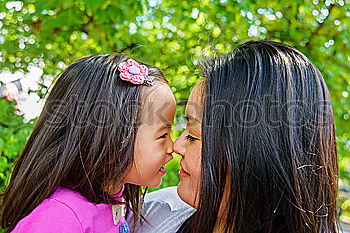 Similar – Image, Stock Photo Happy mother kissing her daughter enjoying a winter afternoon