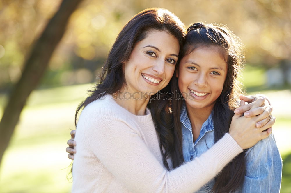 Similar – Two happy young women friends hugging in the street