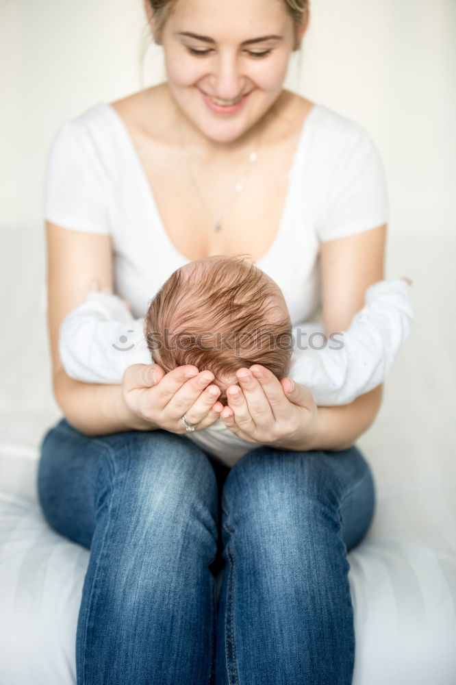 Similar – happy young mother and her baby boy lying on bed and smiling