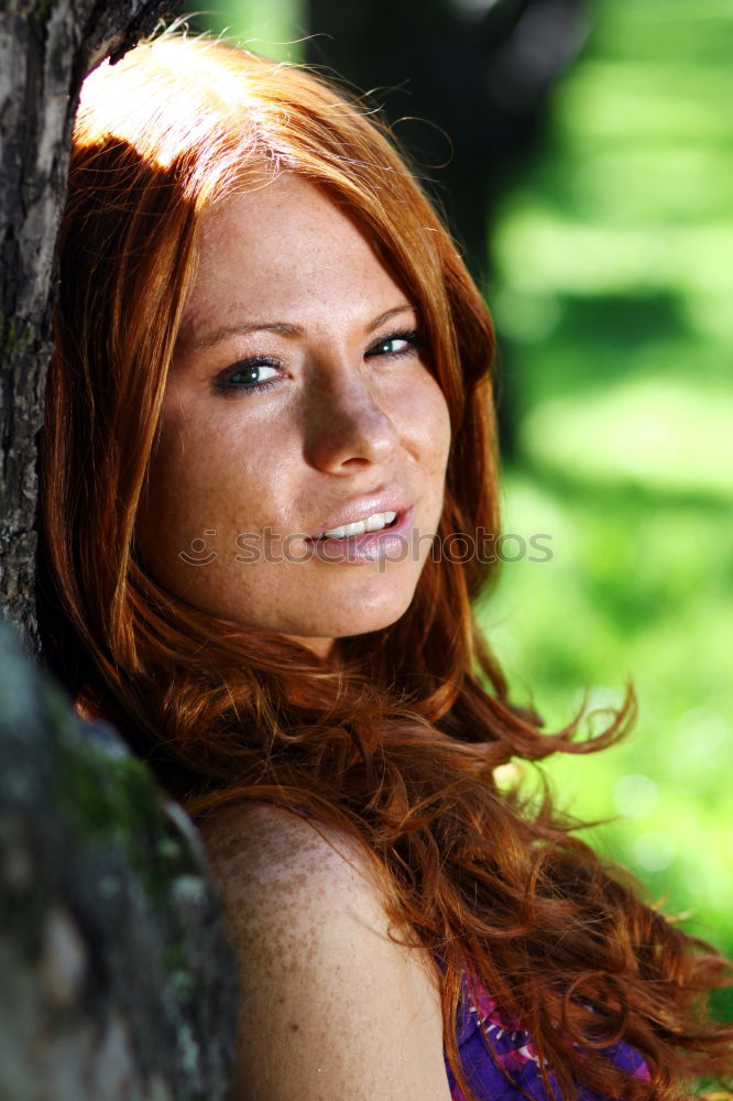 Similar – Young woman with freckles sits on a high flat roof in the evening light and smiles at the camera