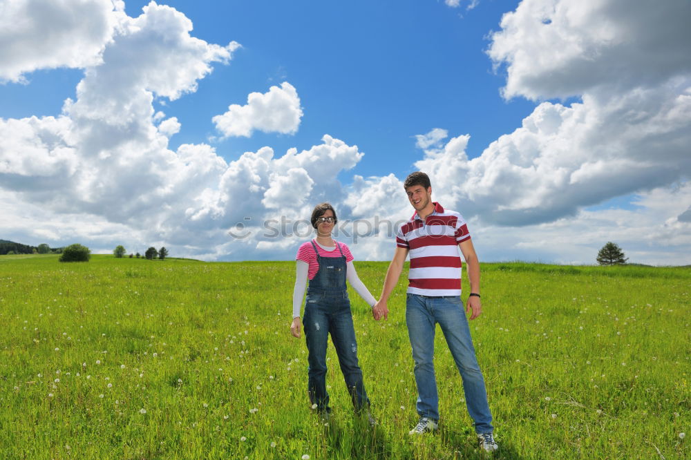 Similar – Couple sitting on a mountain with wide horizon