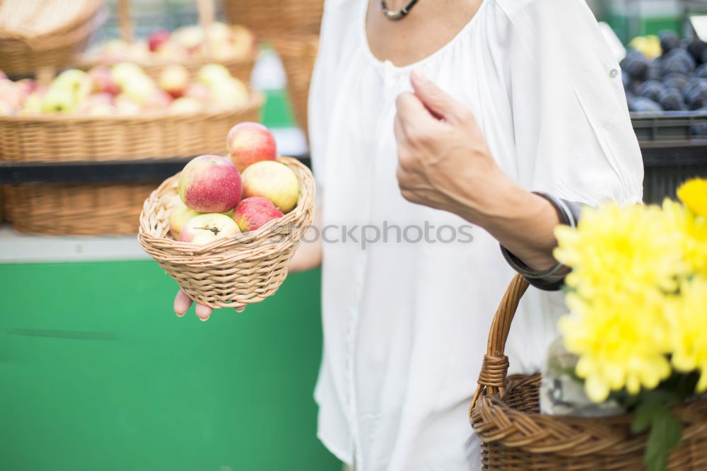 Similar – Image, Stock Photo Young woman shopping for fresh tomatoes at an open-air stall choosing items from a row of wooden boxes