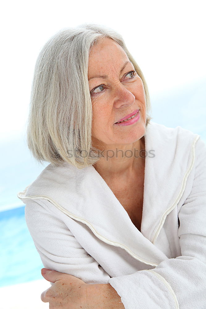 Similar – Ältere alte Frau graue Haare am Schwimmbad sitzend