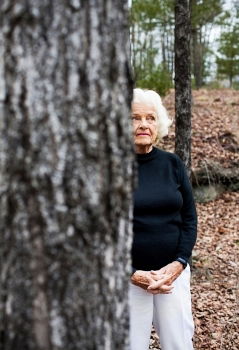 Senior citizen looks up in the forest