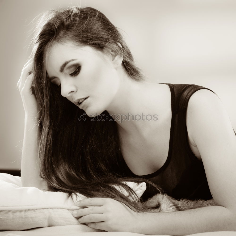 Similar – Young tall woman sitting in sunny kitchen in window frame looking at camera