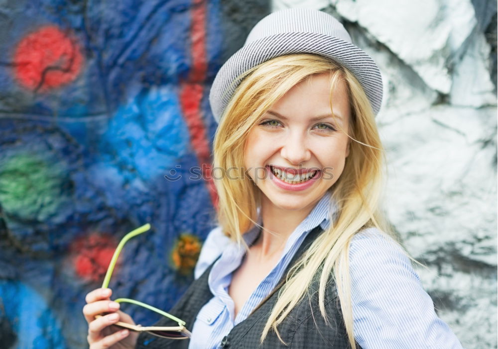 Similar – Image, Stock Photo Smiling woman in yellow dress standing and chatting on her smart phone in front of graffiti painted on corrugated iron