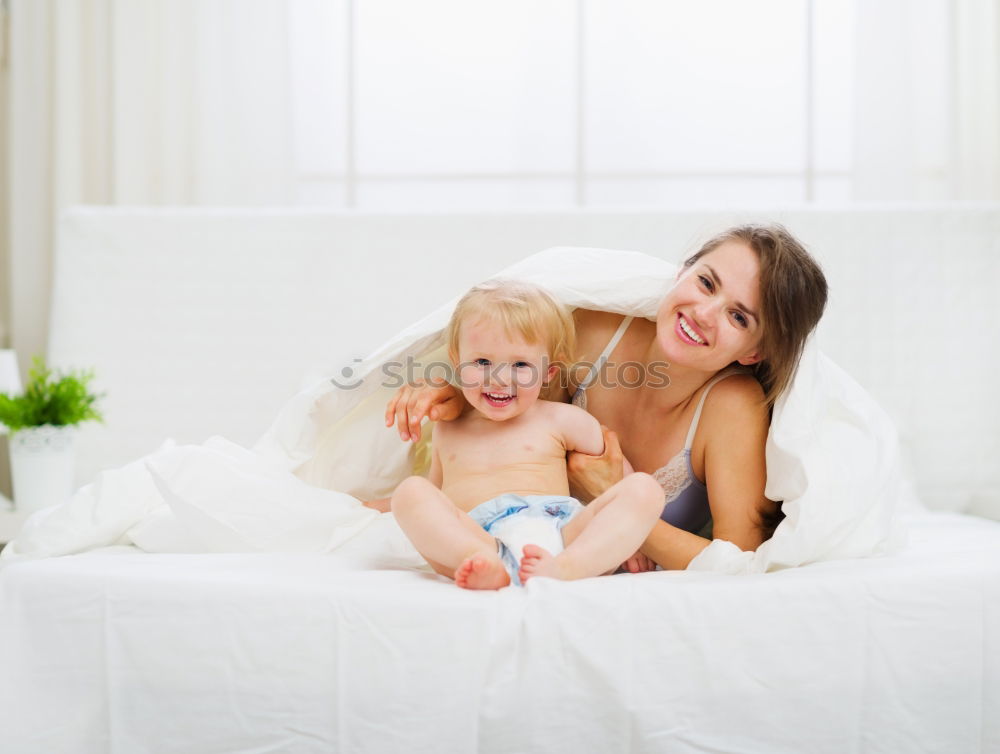 Similar – Two beautiful sisters playing on bed