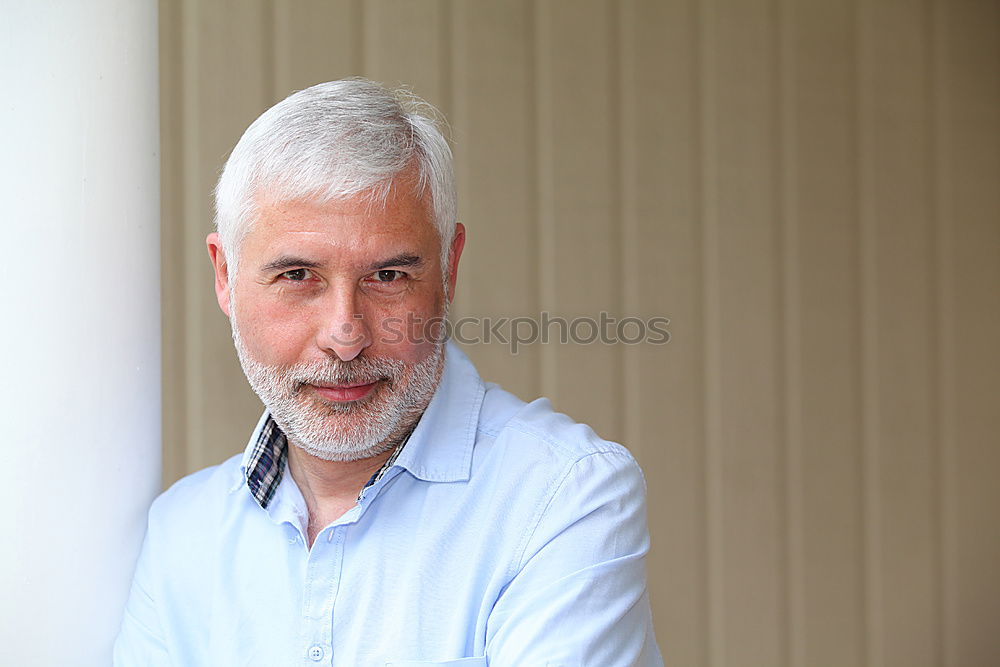 Similar – Portrait of a smiling senior with grey hair and grey beard in front of a grey sky