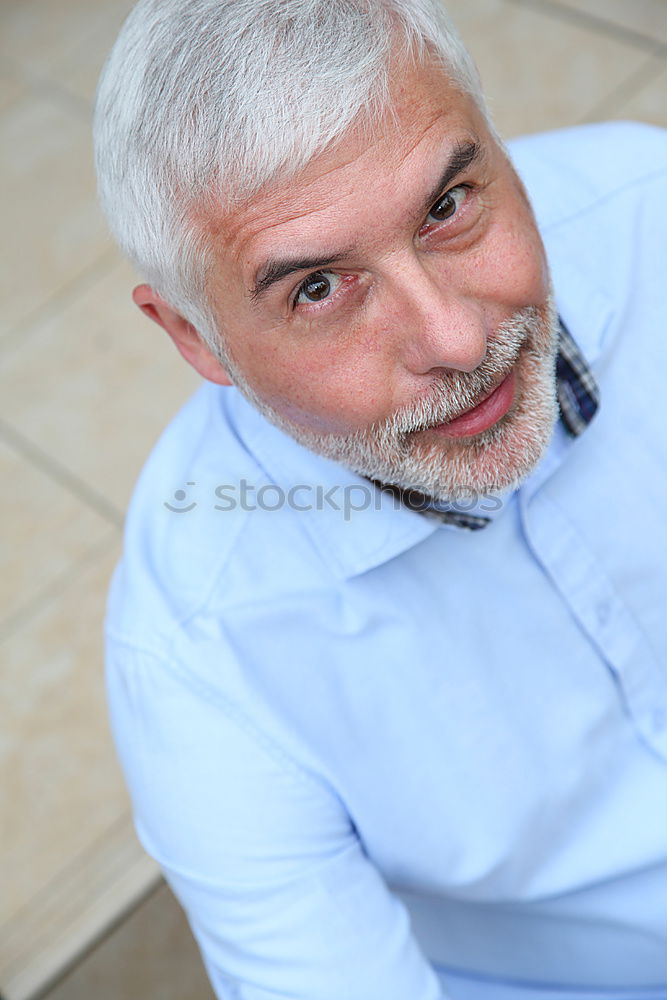 Similar – Portrait of a mature man sitting on steps in the street