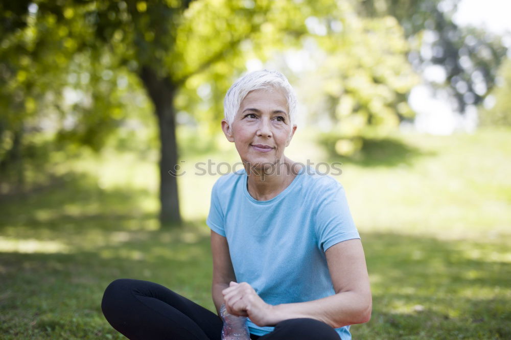 Similar – Image, Stock Photo blonde woman sitting in the grass and stretching in a park