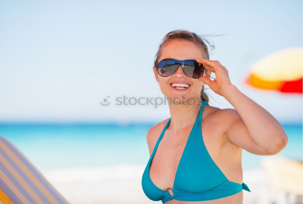 Similar – Woman in bikini sitting on bench near water