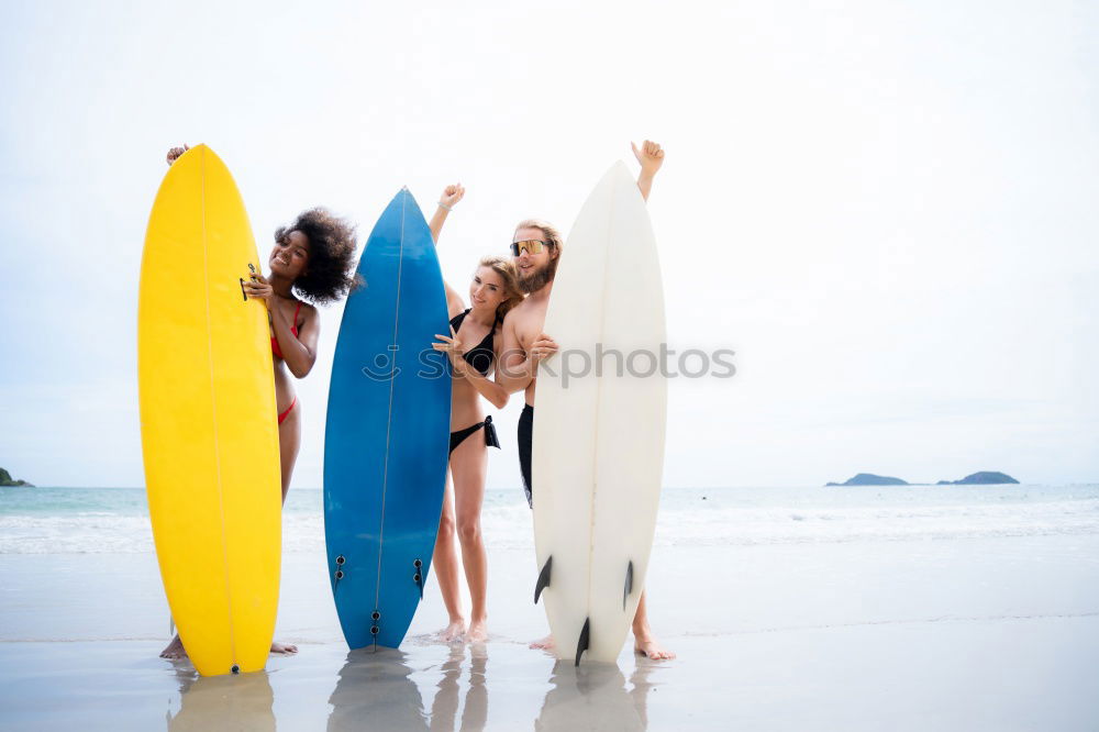 Similar – Group of girls holding surfboard on beach