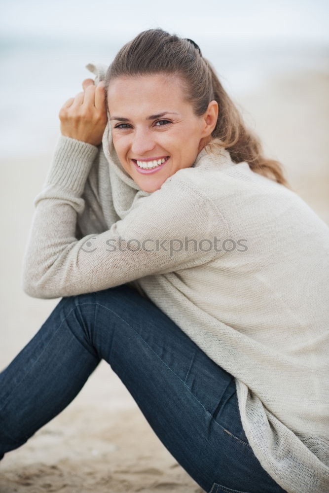 Similar – Woman sitting outdoors putting her hand near the camera.