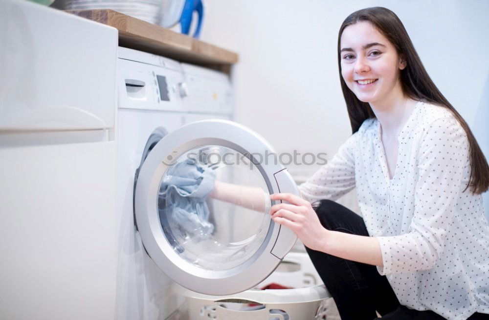 Similar – Woman sitting at laundry machine