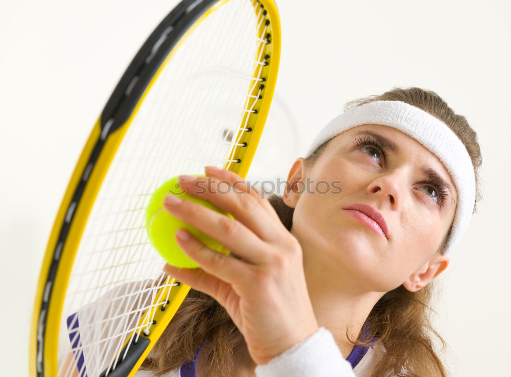 Similar – Face of a young woman hiding behind a featherball bat. Repeating the colour red. Sports grouch. Unsportsmanlike. Defense