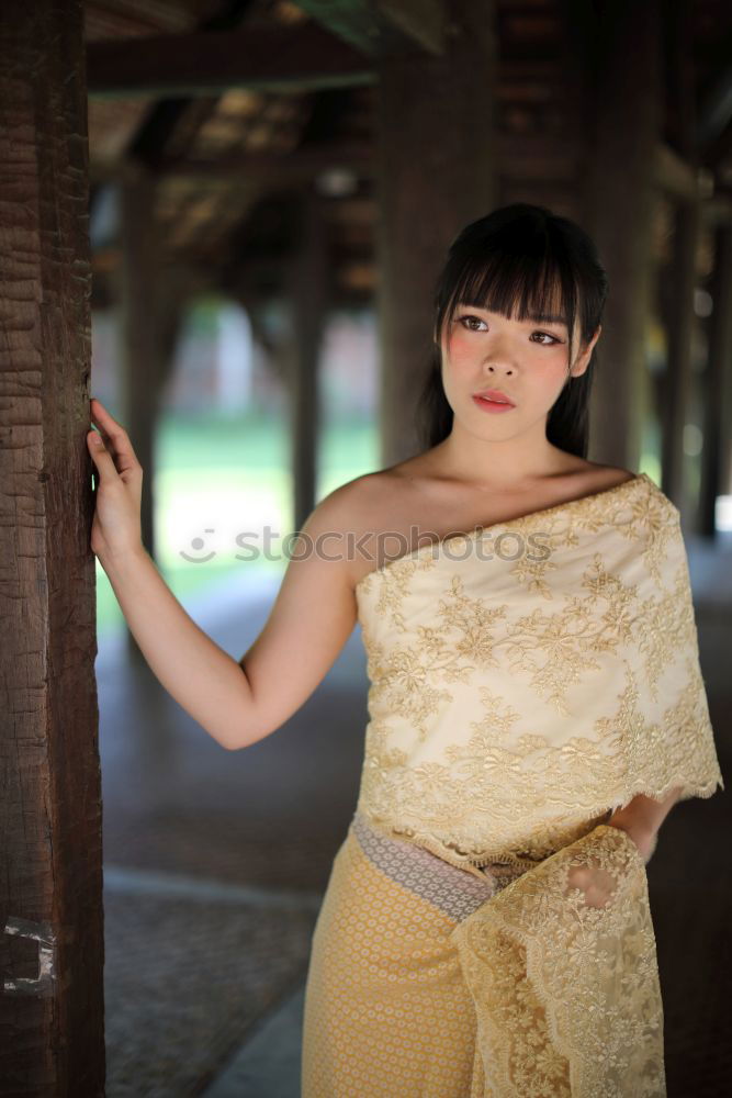 Similar – Asian woman leaning on wall