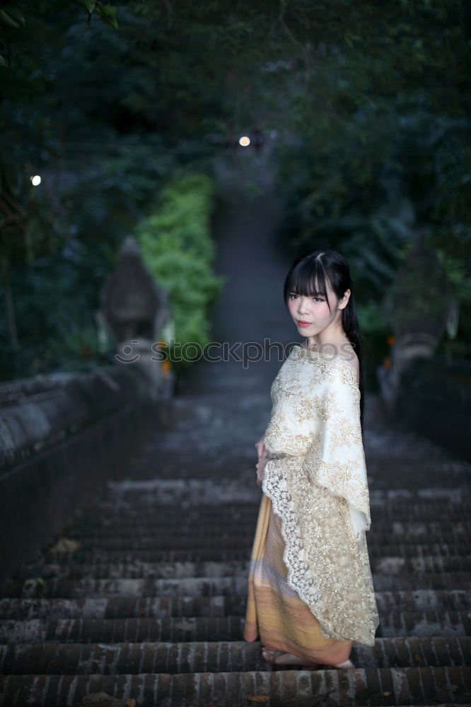 Similar – Pretty Asian woman sitting at pond