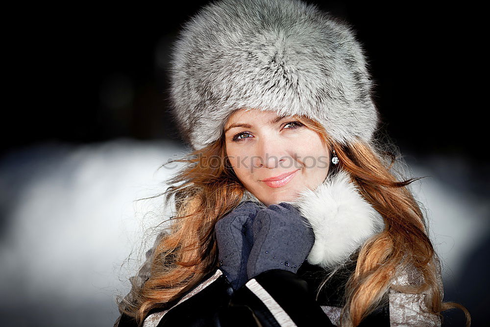 Similar – smiling young woman wearing winter coat with fake fur hood